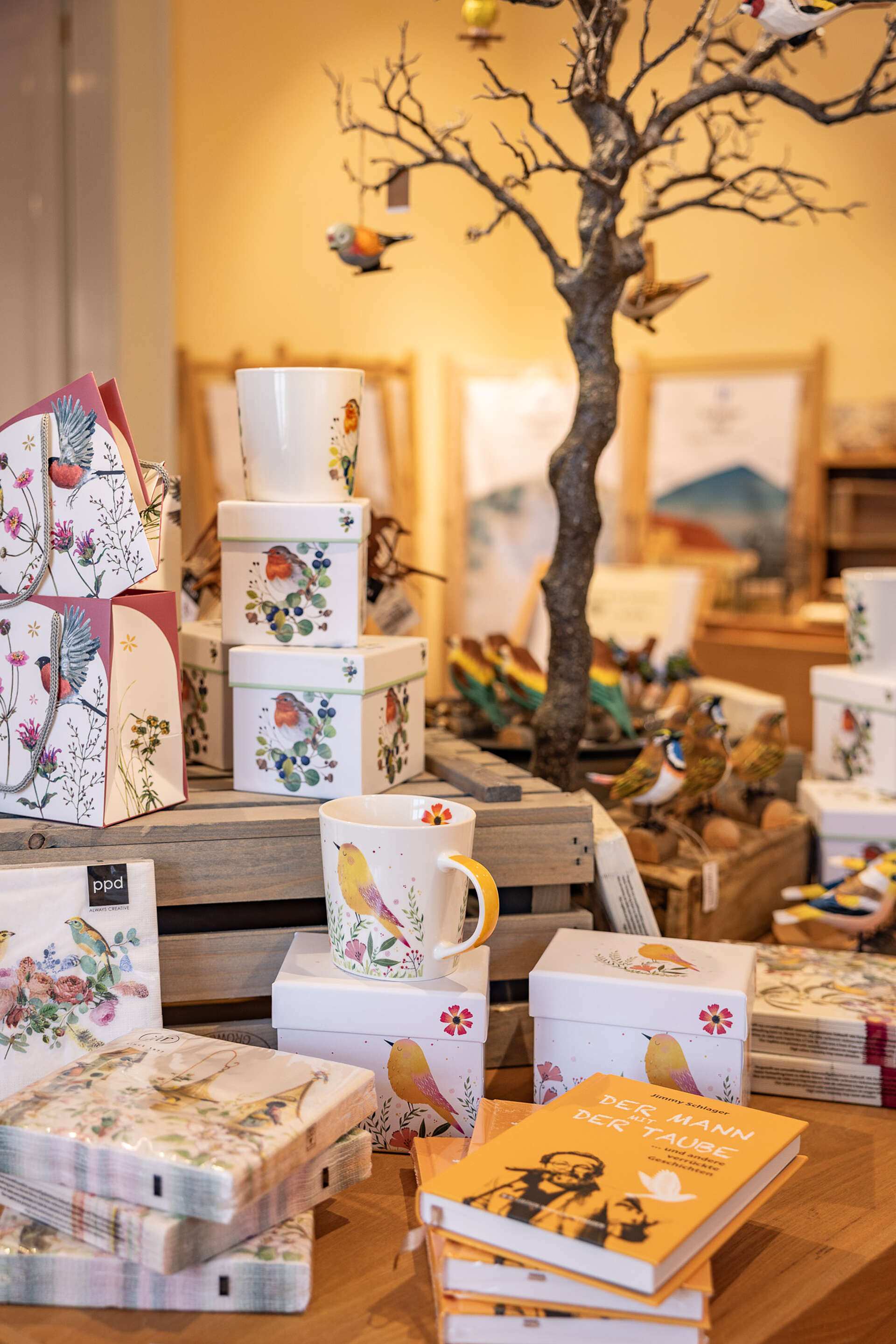 Boxes, mugs, and napkins with a bird motif